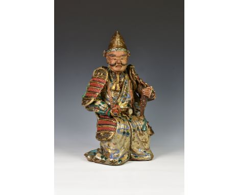 An antique Chinese glazed stoneware figure of a Samurai warrior, possibly Shiwan, 19th century, the seated figure in full arm