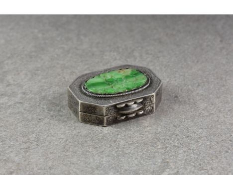 A Chinese silver and jade pill box, probably early 20th century, of rectangular form with canted corners, with an applied ova