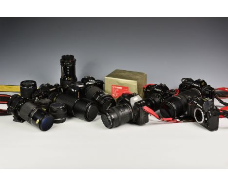 A collection of Canon and Nikon film cameras and lenses, comprising of Canon - Macro lend FD 200mm 1:4 lens; 28mm 2:8 lens; F