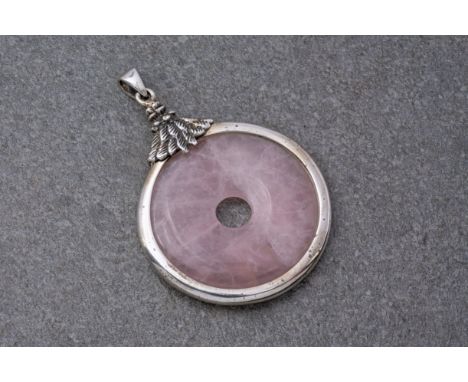 A Rose Quartz pi disc pendant with silver mount, of circular form with feathered mount and hanging loop, marked 925, 1 6/8in.