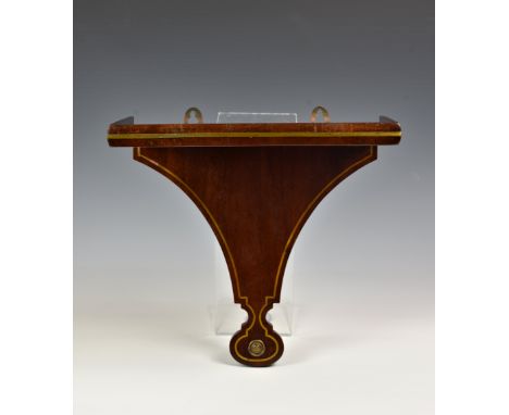 A 19th century mahogany and brass clock bracket, the shaped rectangular bracket with brass stringing, raised lip to platform 