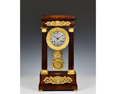 A French mahogany and ormolu four pillar portico clock, 19th century, with silvered Roman dial with ormolu bezel, the twin tr