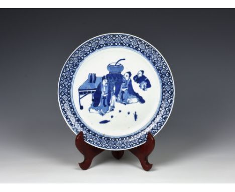 A Chinese late-Ming style blue and white porcelain dish, probably Jiajing, 16th century, painted with two scholars and a youn