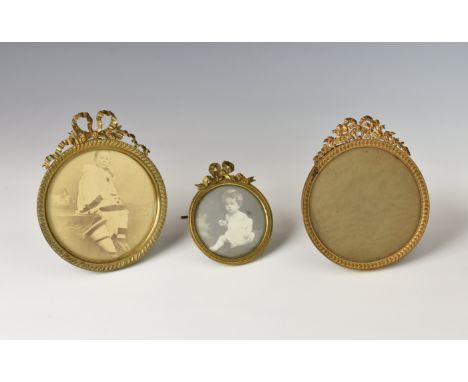 Three Victorian French gilt metal miniature easel back photo frames, of circular form, having filigree and ribbon design, eac