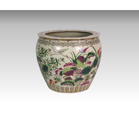 A large 20th century Chinese porcelain fish bowl, polychrome decorated with water lilies and birds, having carp and seaweed t