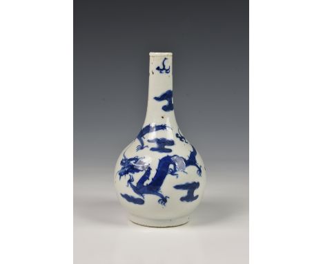 A small Chinese porcelain blue and white bottle vase, probably Kangxi period (1662-1722), painted with four clawed dragons am