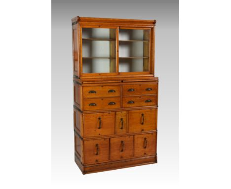 A Globe Wernicke honey oak filing cabinet bookcase, early 20th century, the glazed top with two sliding doors and four shelve