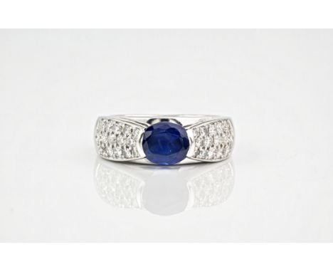 A 1.5ct oval sapphire, diamond and white gold ring, the sapphire set into 18ct white gold with diamond set shoulders totallin