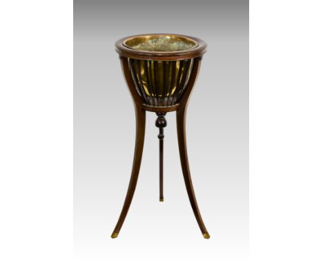 An Edwardian tulipwood and mahogany basket top jardiniere stand, with brass liner and swept tripod supports, 32in. (81.25cm.)