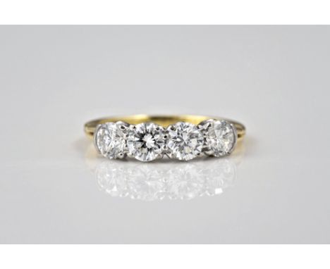 An 18ct yellow gold and diamond four stone ring, made by N. St. J. Paint & Son, Guernsey, the four brilliant cut diamonds tot