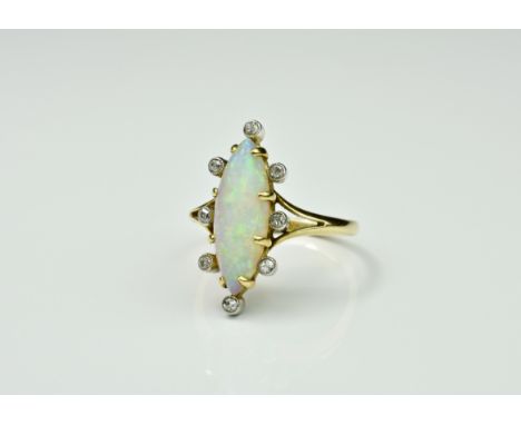 A vintage 18ct gold, opal and diamond cluster ring, the elliptical opal displaying predominantly green, peacock blue and unde