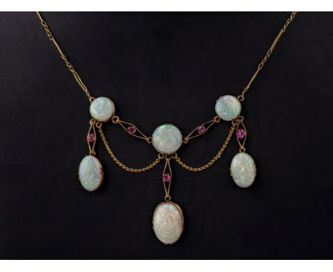 A vintage 9ct gold, opal and ruby fringe necklace, featuring 6 oval and round opals and 5 round cut rubies.