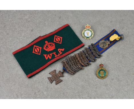 An original Woman's Land Army armband and badge, together with a Women's Land Army and Timber Corps veterans badge and a ' Fo