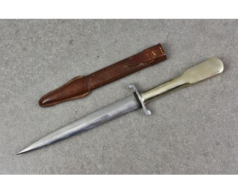 A 1930's German fighting knife, having metal shaped handle, the blade 6 5/8in. (17cm.) long, leather scabbard. * Condition: I