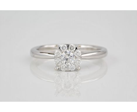 An 18ct white gold and diamond cluster ring, Featuring 9 brilliant cut diamonds. Ring size N.