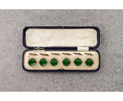 A cased set of vintage, rolled rose gold studs, in their original case and with green centre detailing, thought to date from 