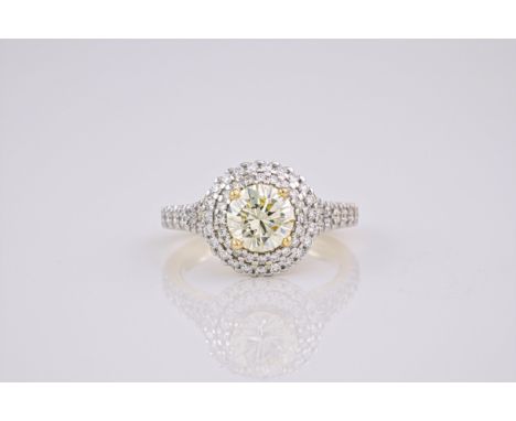 A light yellow diamond and 18ct gold ring, The brilliant cut, light yellow diamond weighing approximately 1.23ct, with a 2 ti
