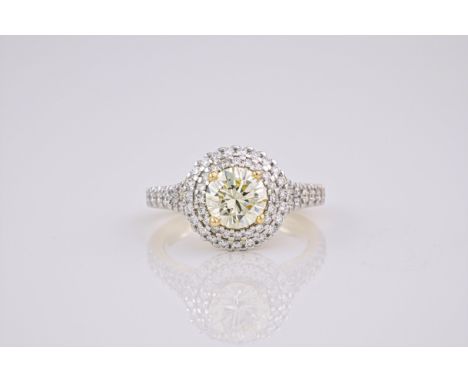 A light yellow diamond and 18ct gold ring, The brilliant cut, light yellow diamond weighing approximately 1.23ct, with a 2 ti