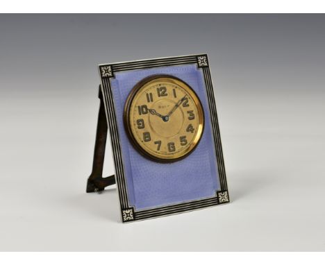 An Art Deco period silver and guilloche enamel strut clock, Henry Matthews, Birmingham 1923, the curved rectangular plate in 