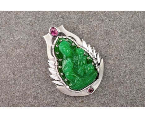 A diamond, jade, silver and tourmaline pendant in the shape of Buddha, the carved, jade Buddha surrounded by 12 bevel set dia