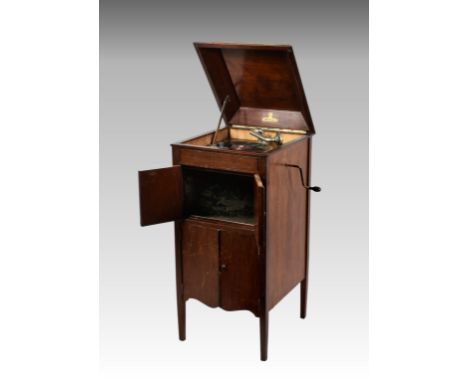A mahogany cased free standing cabinet gramophone by Academy, having two sets of hinged doors to front, the upper set opening