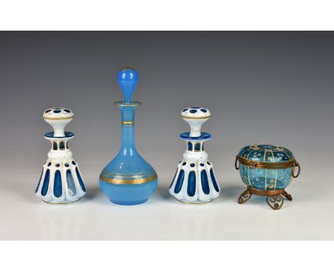 A pair of 19th century cased glass scent bottles, lobed and faceted blue with white overlay, highlighted in gilt, 5in. (12.8c