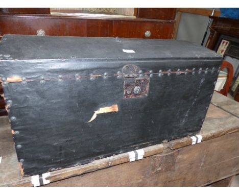 A 19th century clergyman's domed top vestment trunk covered in black oilcloth, with brass studs and iron handles, 30"