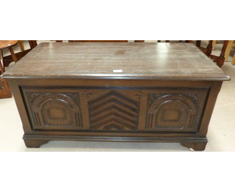 A 1930's oak blanket chest with carved panel decoration