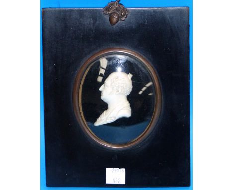 An early 19th century ivory portrait, head and shoulders of a gentleman, in the classical manner, in ebonised frame