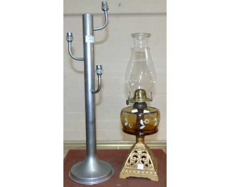 An Art Deco chrome table lamp; an oil lamp with cast iron base