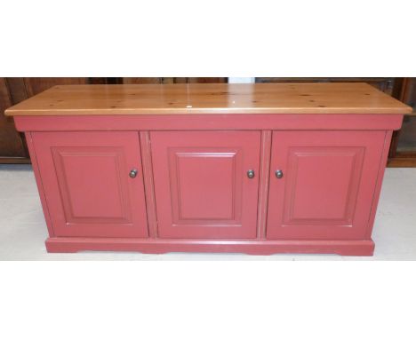 A John Lewis of Hungerford side cabinet with pine top and rust red finish enclosed by 3 raised panel doors