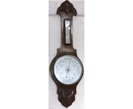A 1930's carved oak barometer
