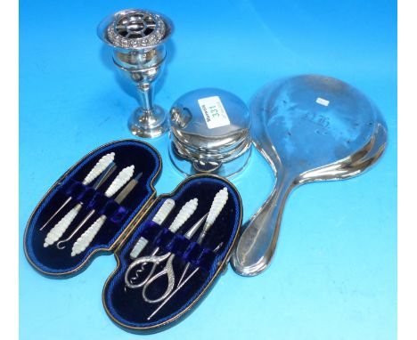 A circular trinket jar on weighted base, stamped 'STERLING'; a posy vase, Birmingham 1924; a cased manicure set; a hand mirro