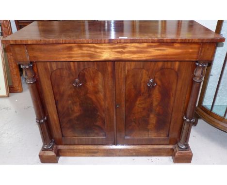 An early 19th century mahogany chiffonier with twin turned and tulip carved side pillars, 2 double arch panel flame figured d