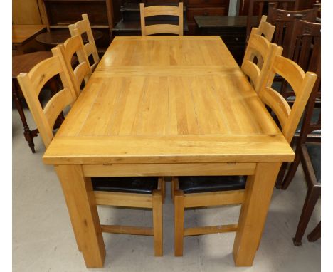 A modern light oak rectangular extending dining table on heavy square and a set of 8 dining chairs