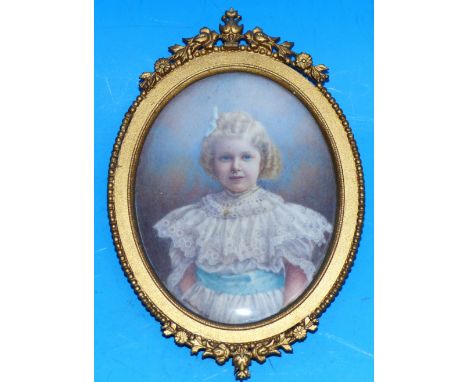 An early 20th century oval miniature:  half-length portrait of a girl in white lace dress, in ormolu frame, height 3"