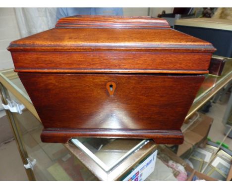 A 19th century style sarcophagus shaped tea caddy and a pair of turned wood candlesticks