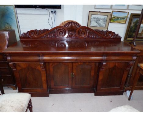 A Victorian mahogany 4 door sideboard with raised scroll carved back, 3 pulvinated frieze drawers and ogee arch panel cupboar