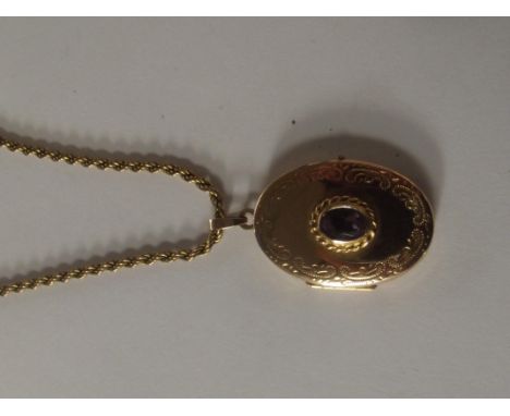9 carat gold locket with central amethyst on a 9 carat gold rope chain, weight 10.5 grams