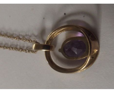 9 carat gold pendant set with amethyst diamonds on a 9 carat gold chain