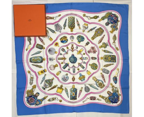 Hermes silk scarf, 'Qu'importe le Flacon', designed by Catherine Baschet c1988, decorative scent bottles on a white and blue 