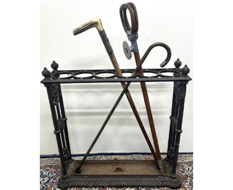 Early 20th century painted cast iron rectangular six division stick stand, floral and rosette cast end supports with urn fini