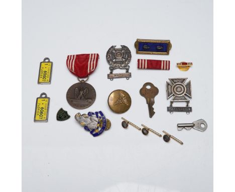 Collection including U.S. military-themed pins, medals, insignias, and buttons. Also, includes keys and cufflinks. Items incl