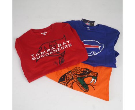 Group of three fan apparel shirts representing NFL and NCAA teams. Includes a long-sleeve red Tampa Bay Buccaneers shirt with