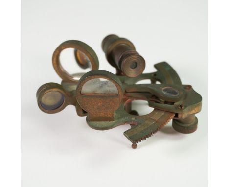 An early 20th-century vintage brass sextant, a precision navigational instrument used for celestial navigation at sea. Constr