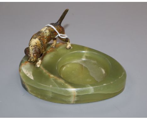 A cold plated bronze model of a dog and a green onyx ashtray