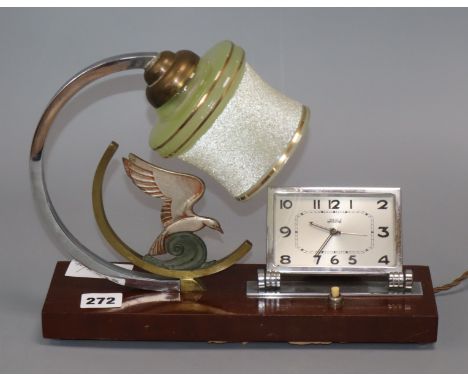 An Art Deco figural lamp / clock