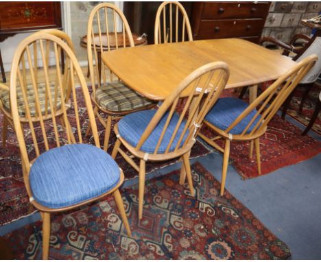 An Ercol elm drop leaf dining table and six Ercol chairs L.138cm