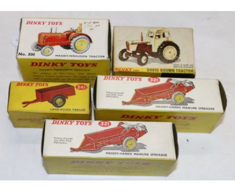 Five Dinky Toys including 300 Massey-Ferguson Tractor, 305 David Brown Tractor, two 321 Massey-Harris Manure Spreaders and 34