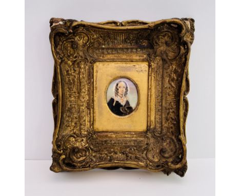 A gilt framed portrait miniature of Elizabeth Barrett Browning and Flush her cocker spaniel, inscribed to reverse The Portrai